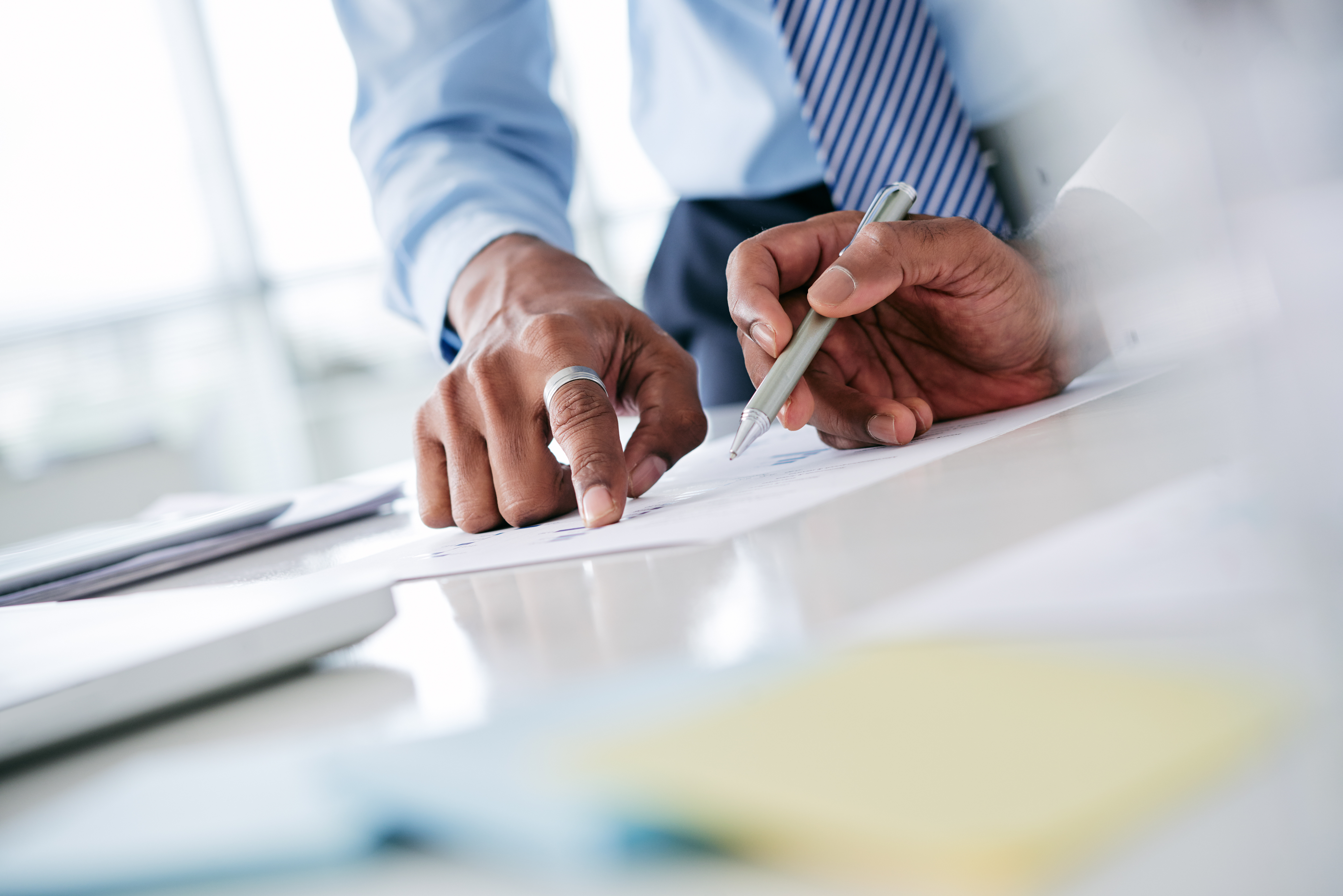 http://Two%20professionals%20pointing%20and%20writing%20on%20paperwork
